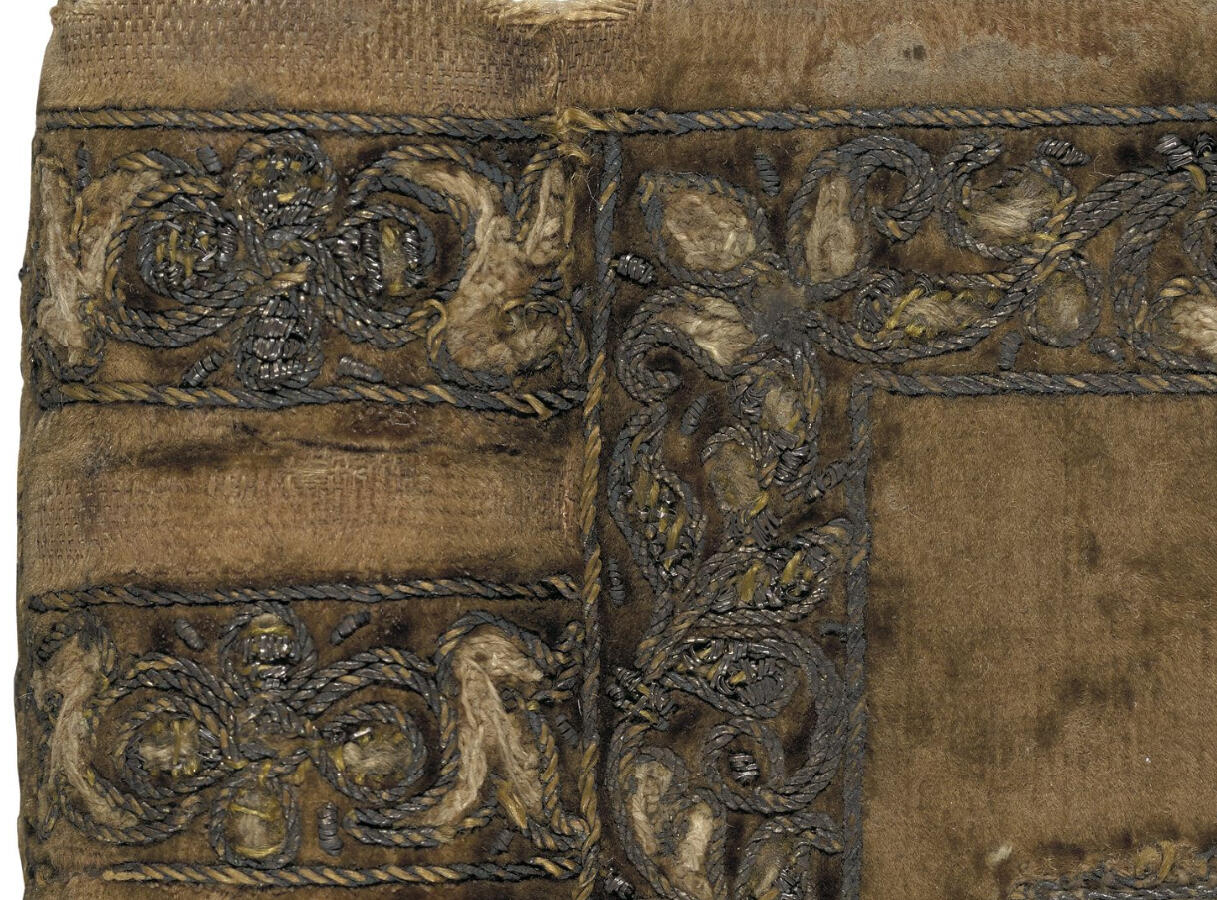 A close-up of stumpwork on a book by Esther Inglis. The thread is wrapped in very thin wire. This cover was also decorated with hundreds of tiny pearls.